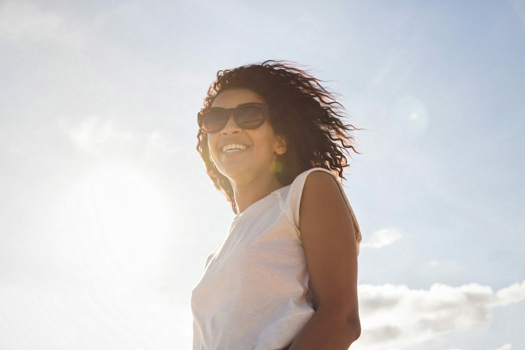 Happy smiling african woman in sunglasses