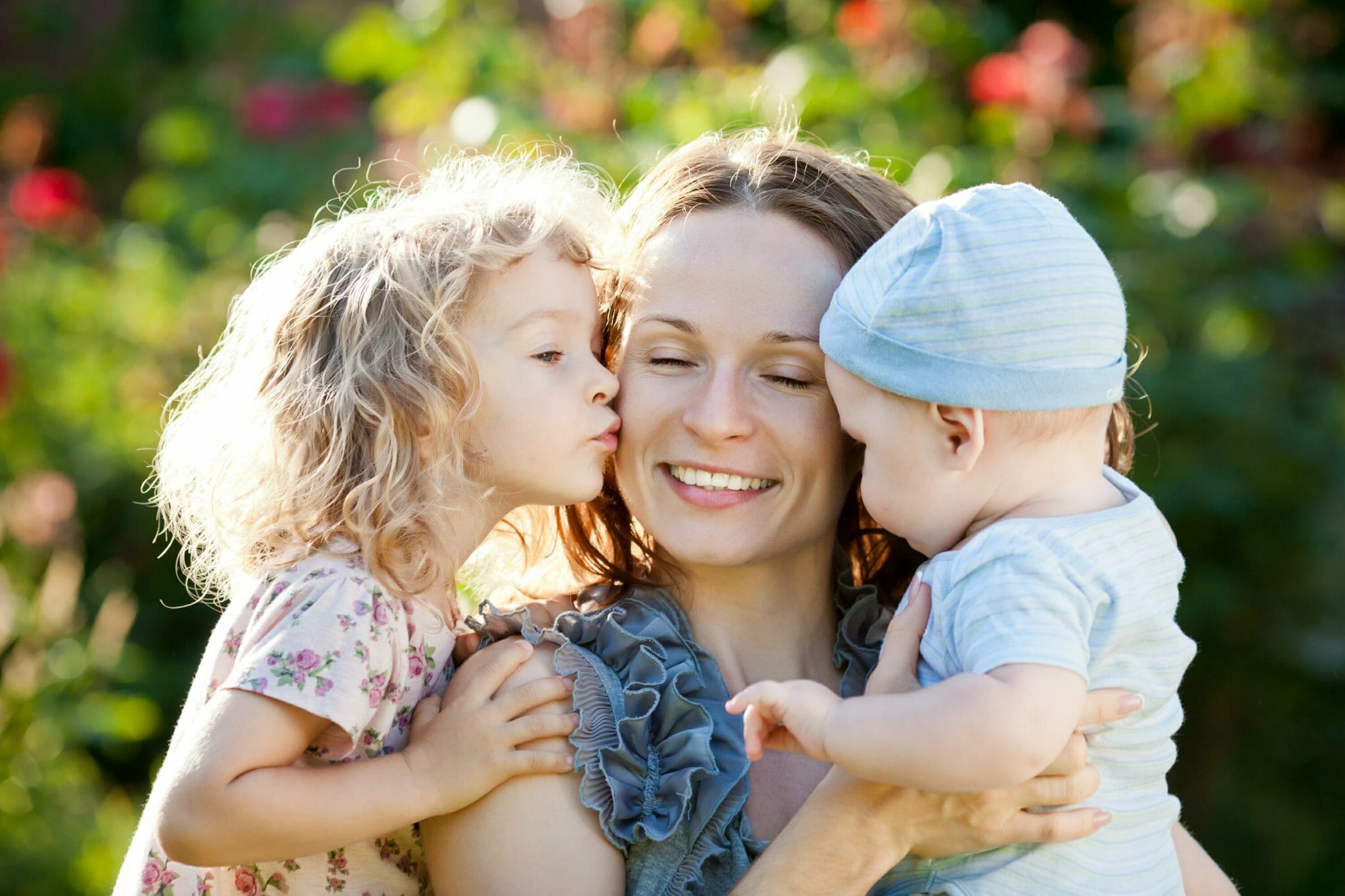 Happy woman with child and baby