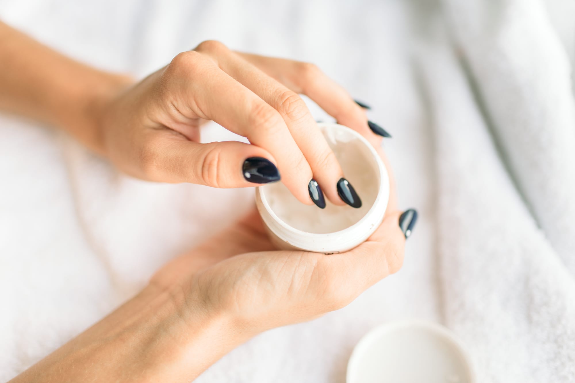 Female person hands with beauty product closeup