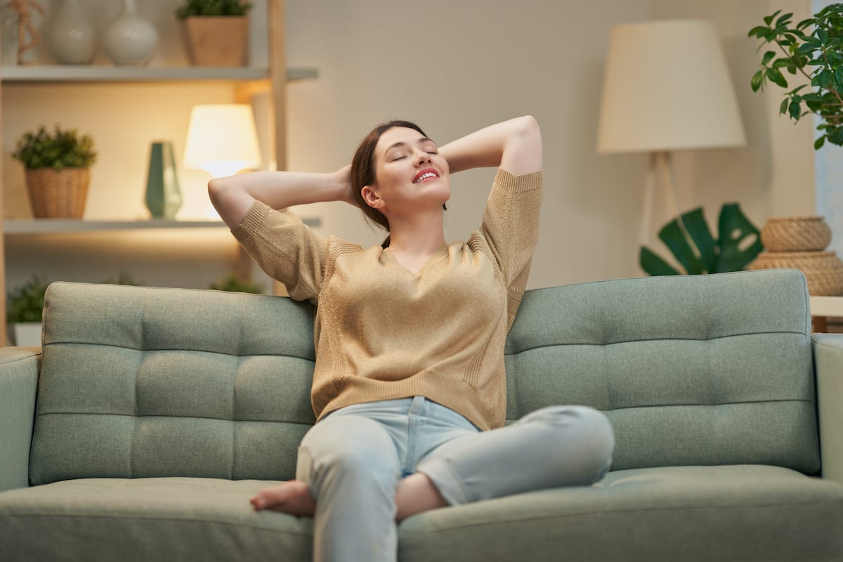 a young woman resting at home on her sofa