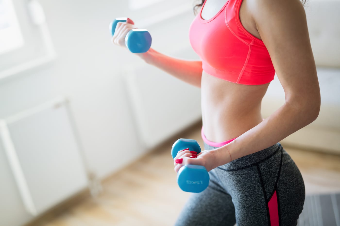 woman working out by lifting weights