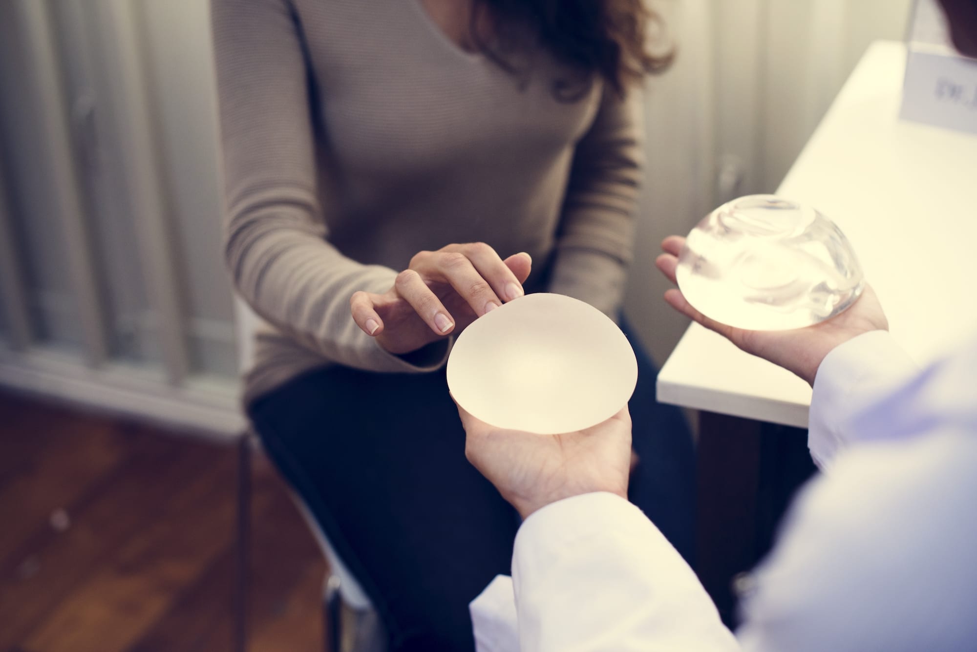 woman deciding on breast augmentation inserts