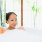 beautiful young woman relaxing in spa bathtub