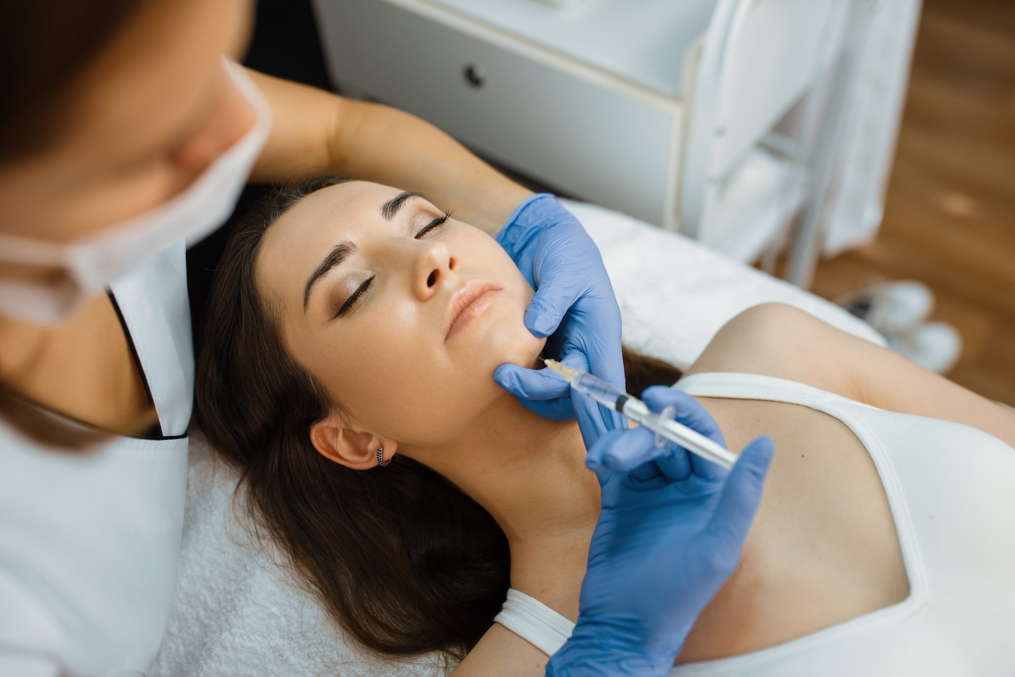 woman receiving botox injection into chin