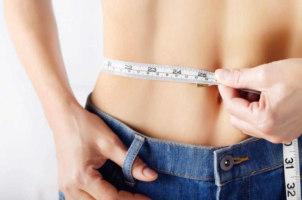 a tape measure wrapped around a woman's waist