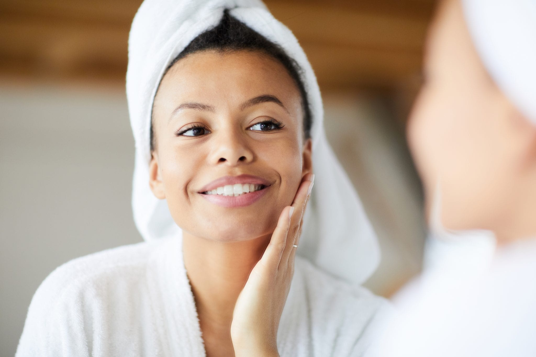 Fresh Skin Young woman in a towel touching her face