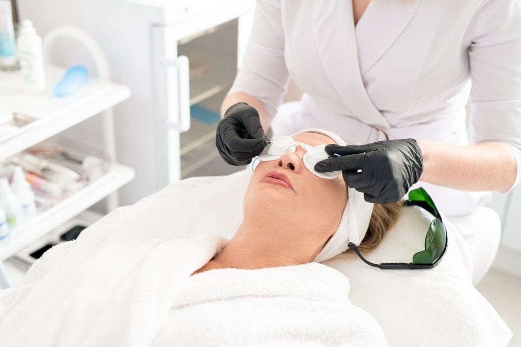 Doctor preparing a patient for laser surgery