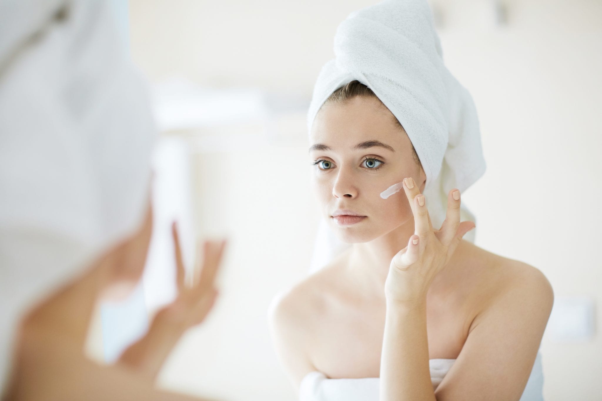 woman putting on cream