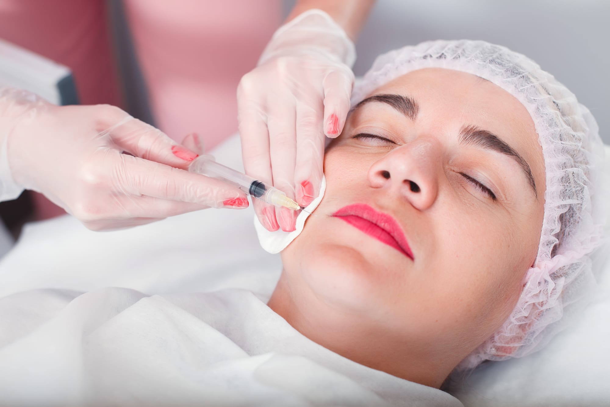 Injection syringe in the woman's face.