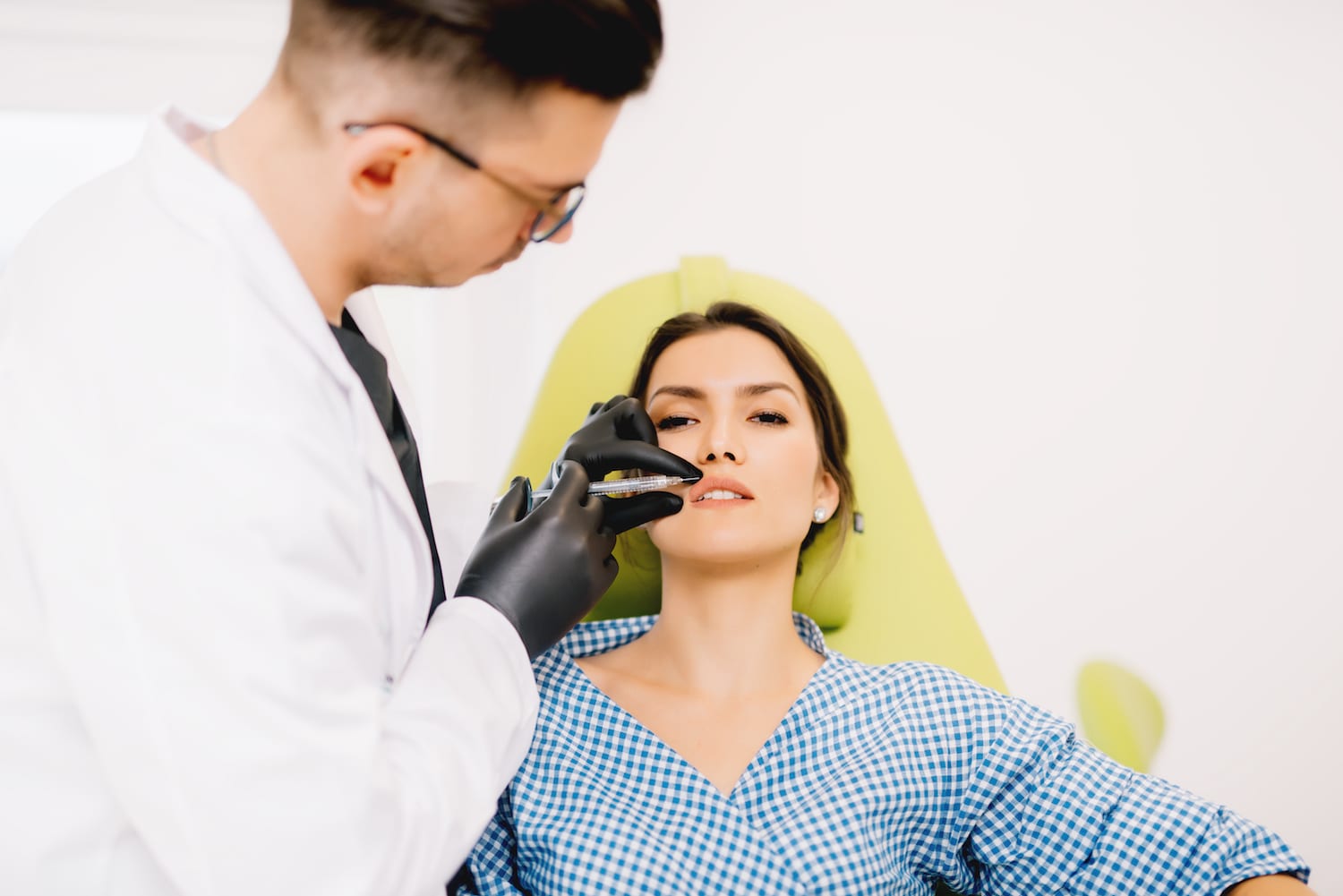 female patient receiving injectable filler from doctor