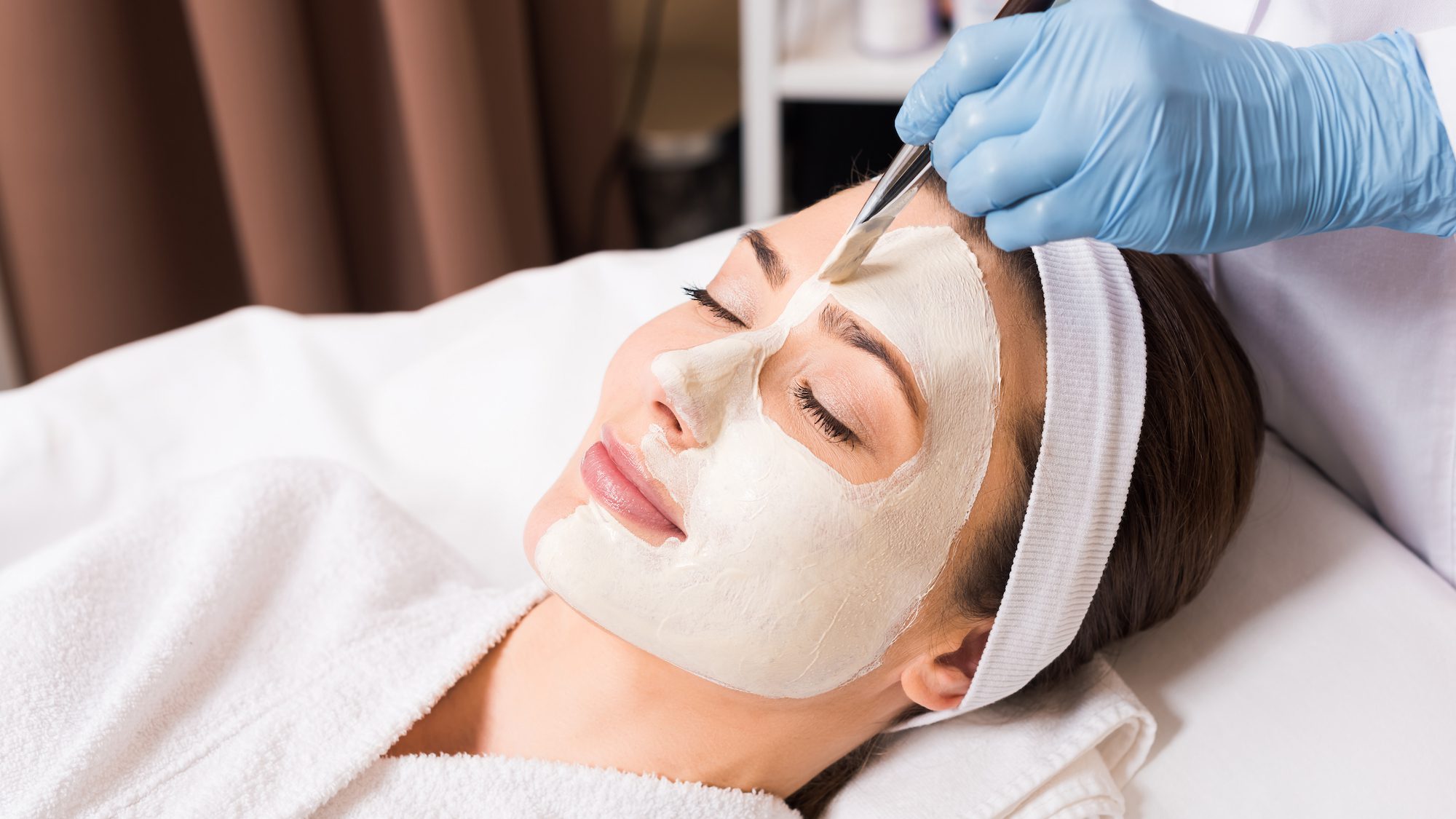 woman getting facial mask