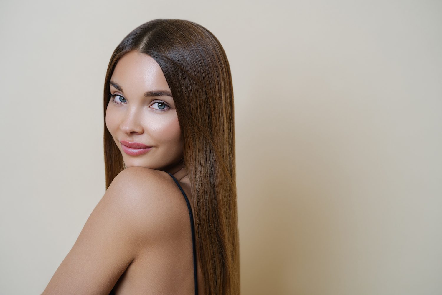 young brunette model on tan background