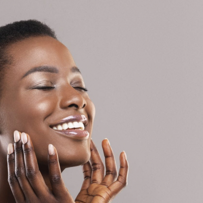 dermafile banner young woman happily touching her face